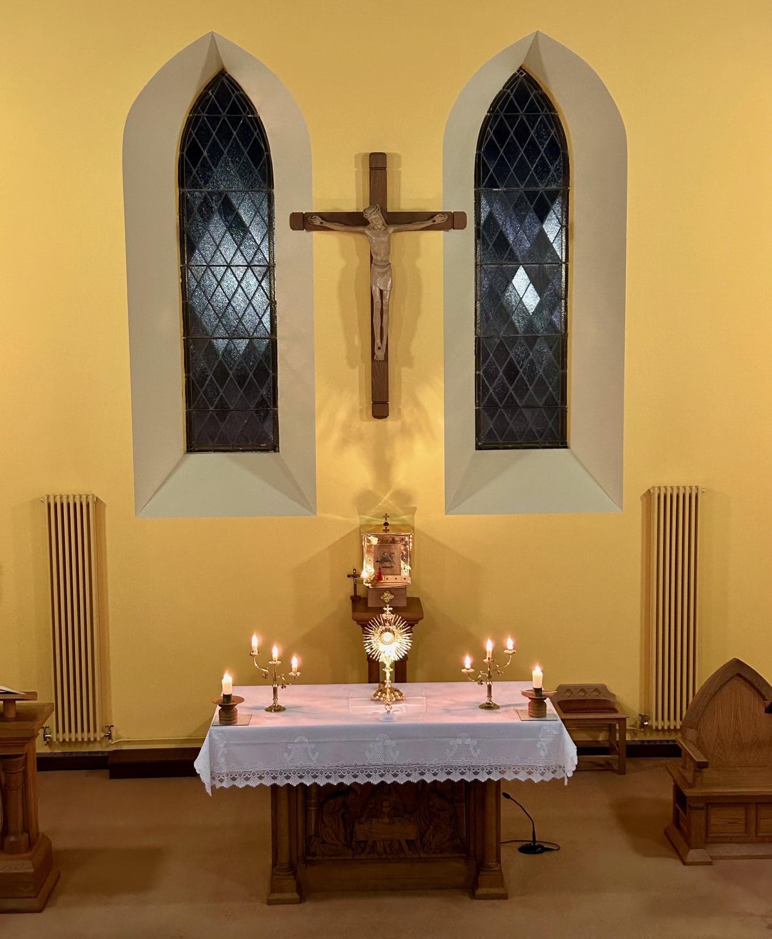 The altar of St Mary's Church, Rouskey, with the Blessed Sacrament exposed in a monstrance between lit candles.